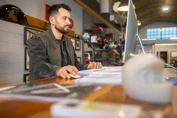 Motorcycle shop employee working at a computer